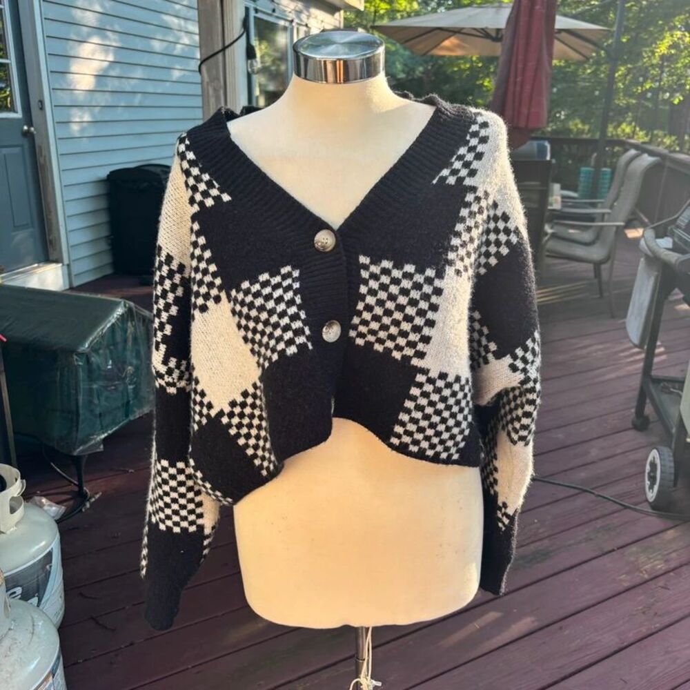 Timing in black-and-white checkered sweater